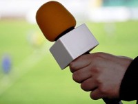 hand hold microphone for  interview during a football mach